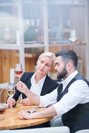 Professional cavists with wine samples examining their colorの写真素材