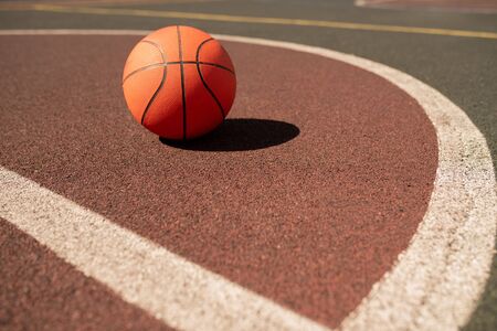 Ball for playing basketball lying on sports field or stadiumの写真素材