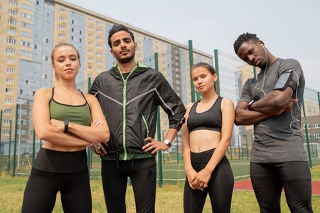 Young sporty men and women in activewear standing in urban environmentの写真素材