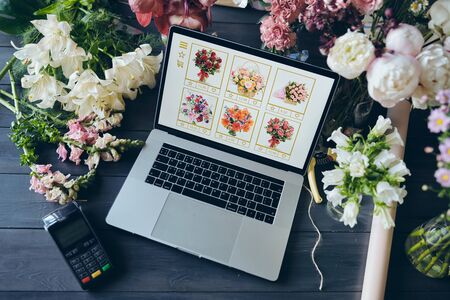 Above view of open laptop with flower shop websiteの写真素材