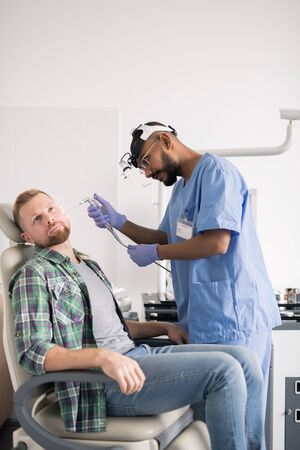 Medical professional standing by patient during medical or hygenic procedureの写真素材
