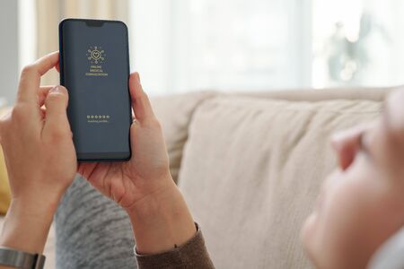 Hands of restful girl with smartphone going to get online medical consultation