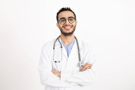 Successful young male clinician with his arms crossed by chest looking at youの写真素材