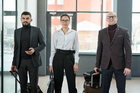 Group of elegant business travelers of various ethnicities and ages in airport