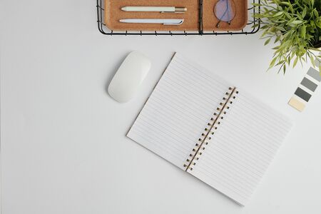 Flat layout with computer mouse, open notebook with blank pages, palette. basket for pens and green...