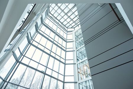 Glass wall and window of large contemporary business center or office building that is part of its...