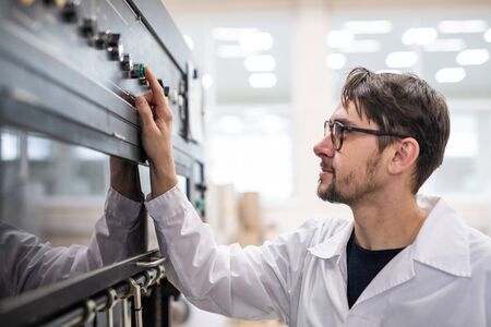 Young specialist working at factoryの写真素材