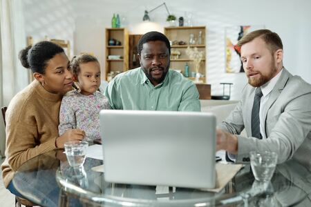 Consultant showing presentation to ethnic family
