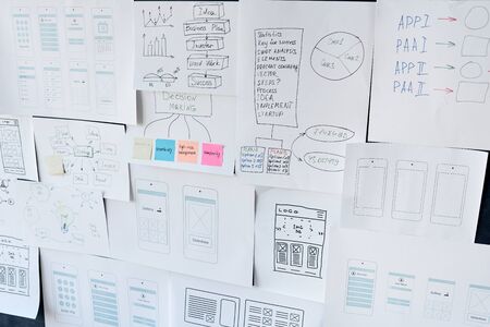 Horizontal no people shot of papers with new application project schemes and sketches fixed on board
