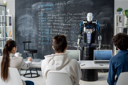 New generation robot presenting technical data to group of students