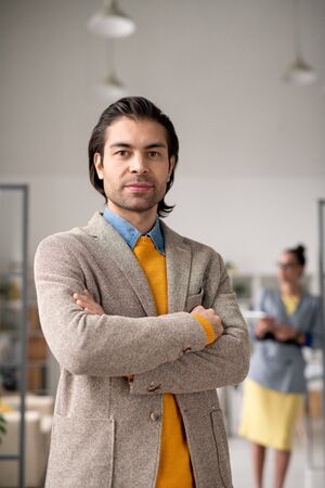 Confident businessman in smart casualwear crossing his arms on chest