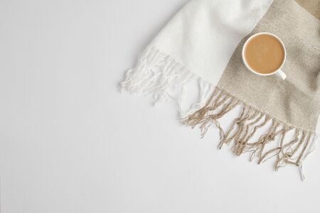 Flat lay of cup of fresh aromatic cappuccino on checkered linen or cotton scarfの写真素材