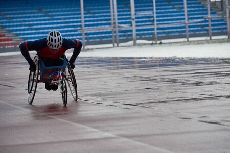 Determined paraplegic sportsman racing in handcycle at outdoor stadiumの写真素材