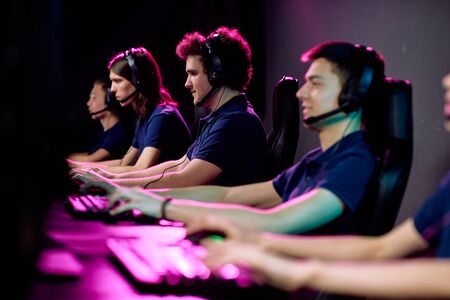 Row of guys in casualwear and headsets sitting in black leather armchairs