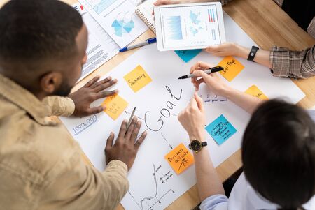 Hands of analysts or brokers discussing financial data and making goals tableの写真素材