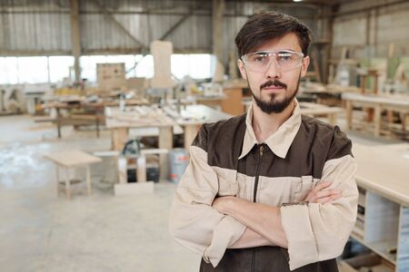 Young serious worker or engineer of furniture producing factory in uniformの写真素材