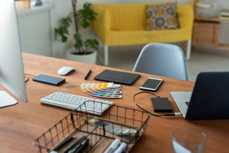 Graphic designers workplace with color swatch, digitizer, smartphone and computers in home officeの写真素材
