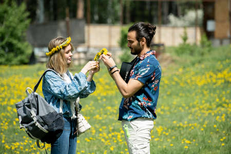 Young man making wrench with girlfriend while they spending weekend in countryside