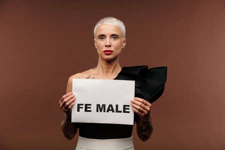 Young blond woman in black tanktop showing paper with syllable fe and word male