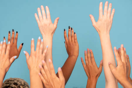 Hands of large group of women of various ethnicities with white and dark skinの写真素材