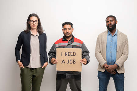 Contemporary young intercultural jobless people standing in front of cameraの写真素材