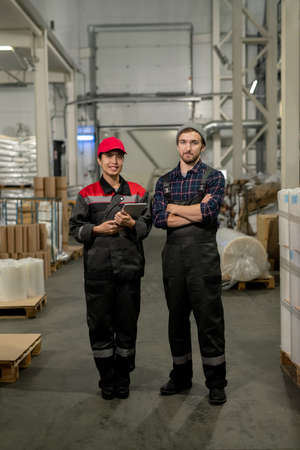 Successful young male and female engineers of large contemporary plantの写真素材