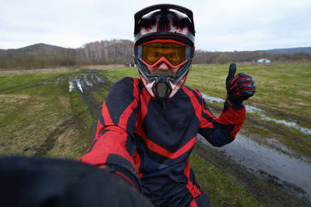 Motorcross rider posing for selfieの写真素材