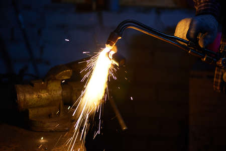 Professional welder working on something using torchの写真素材