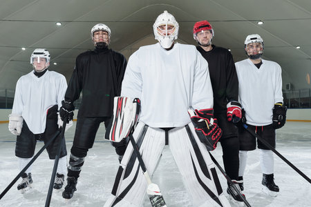 Professional hockey players and their trainer in gloves, skates and helmetsの写真素材