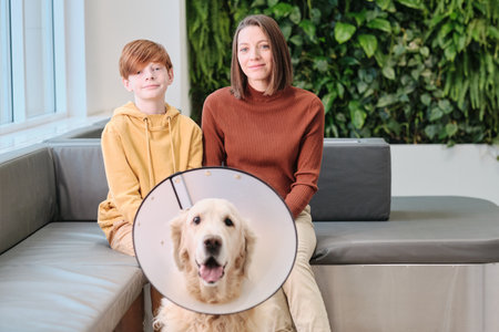 Family with dog at clinicの写真素材