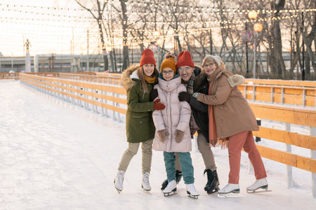 Happy family on ice rinkの写真素材