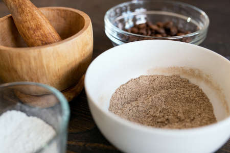 Bowls with pounder, glassware with coffee beans and titanium dioxide powderの写真素材