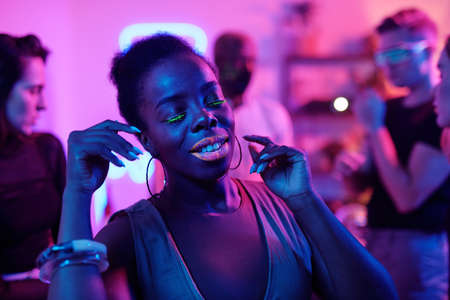 Happy young glamorous woman of African ethnicity keeping her eyes closedの写真素材