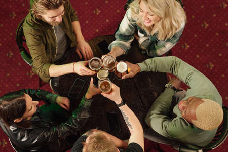 Friends toasting with beer in the barの写真素材