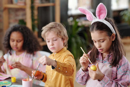Children painting Easter eggsの写真素材