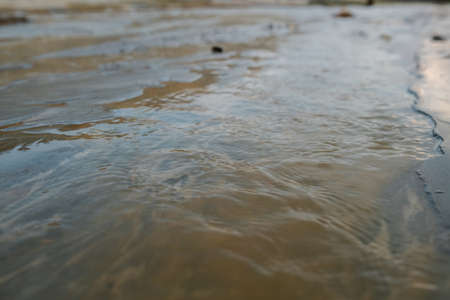 Part of dirty river with polluted water flowing somewhere in distant and abandoned area where no life is possible because of toxicityの写真素材