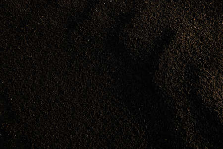 Part of dirty, toxic and infertile dark soil that can be evaluated as sign of environmental catastrophe or copyspace for toxicity announcementの写真素材