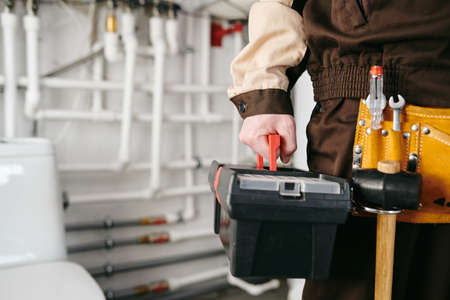 A person holding toolbox with handtools for repair works