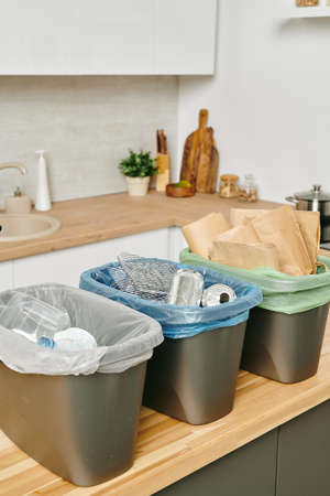 Group of plastic buckets for waste standign on kitchen tableの写真素材