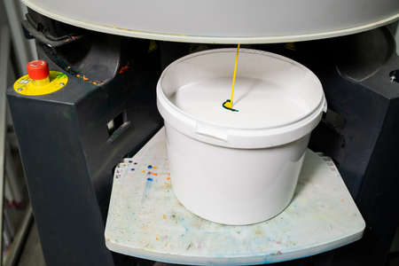 Plastic bucket with white paint for household needsの写真素材