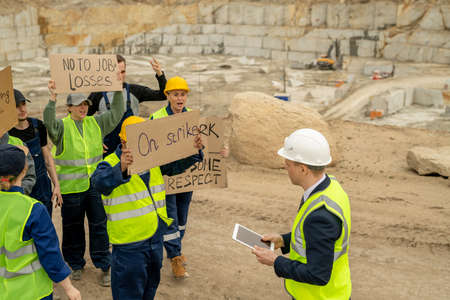 Protestants with placards standing in front of contractor