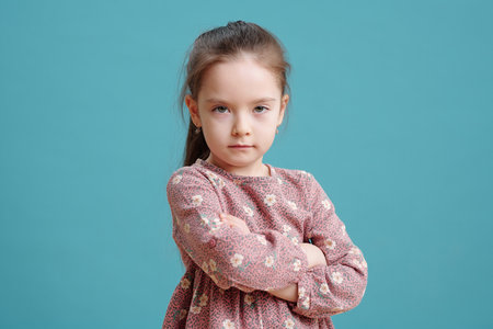 Cute Caucasian little girl looking at you seriouslyの写真素材