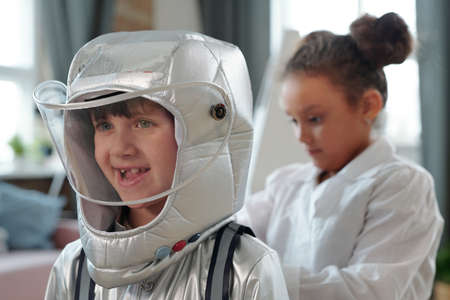 Little boy and girl wearing uniform of spaceman and doctor