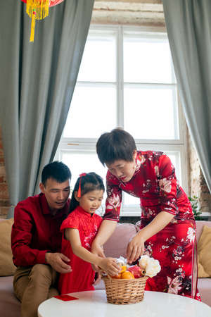 Chinese people preparing snack for picnic in home environmentの写真素材
