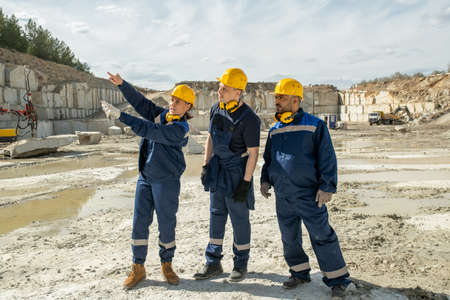 Female builder showing new building area to male colleagues