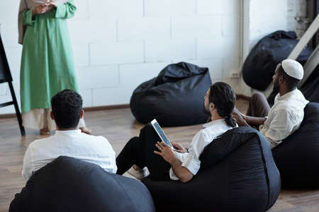 Row of young Muslim businessmen in formalwear attending seminarの写真素材