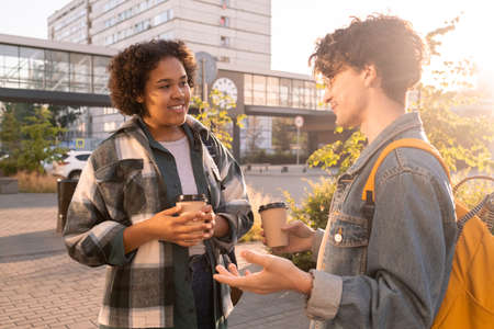 Two students of college having drinks after classes in urban environmentの写真素材