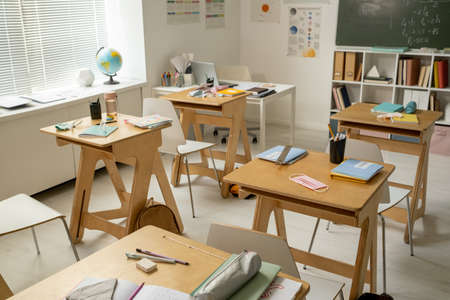 Group of workplaces of secondary schoolchildren in large classroomの写真素材
