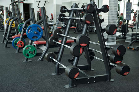 Sets of various weights for bodybuilding and weightlifting in side large contemporary gym of fitness centerの写真素材
