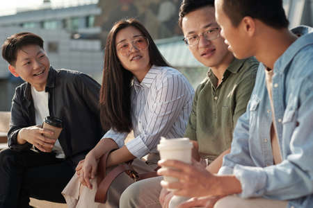 Group of colleagues discussing working points at outdoor meetingの写真素材